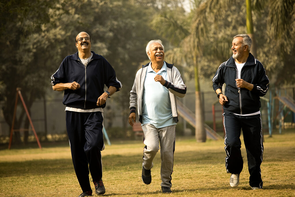 Three senior men jogging at park trying to stay fit and healthy at older age