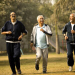 Three senior men jogging at park trying to stay fit and healthy at older age